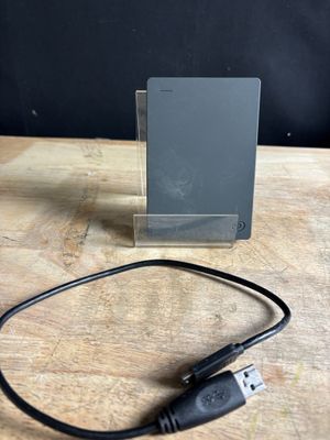 a usb cable connected to a small device on a wooden table