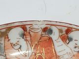 a plate with a picture of a woman and two men on it