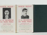 three books are lined up in a row on a white surface