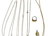 several necklaces and rings are arranged on a white surface