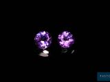 a pair of purple amethtites on a black background