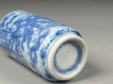 a blue and white vase sitting on a table