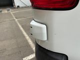 a close up of the rear end of a white car