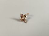 a close up of a gold ring with a bee on it