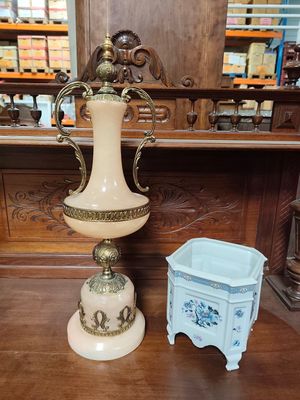 two vases sitting on a wooden table in a store