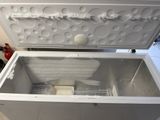 a white chest freezer sitting inside of a kitchen