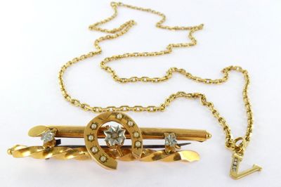 gold plated brooch with crystal stones on a gold chain