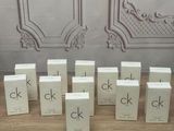 several boxes of perfume sitting on a table in front of a wall
