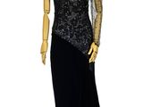 an image of a mannequin wearing a black dress with sheer sleeves