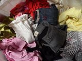 a pile of clothes in a plastic bag on the floor