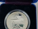 an image of a silver coin in a velvet case