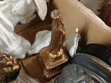 a box with a statue of an angel and other items