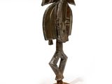 an image of a bronze statue of a bird on a wooden base