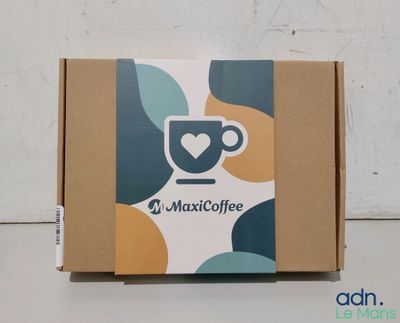 a close up of a box with a cup of coffee on it