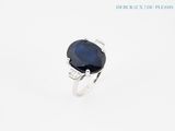 a close up of a ring with a blue stone on it