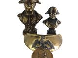 brass statue of a man and a woman in a boat with a coin
