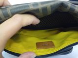 a person that is holding a purse in their hand