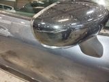 reflection of a car in the side mirror of a silver car