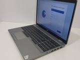 a laptop computer sitting on a table with a blue screen
