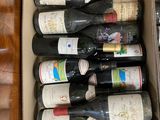 many bottles of wine in a box on the floor