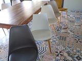 many chairs around a table in a room