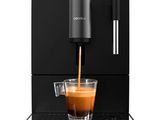 a coffee machine with a cup of coffee being poured into it