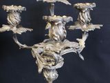 a silver metal candelier with four candles on it