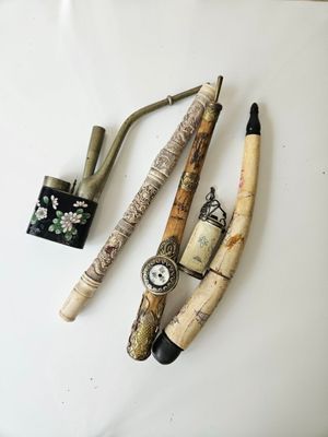 three different types of pipes and a lighter on a table