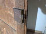 a close up of a wooden door with a latch on it