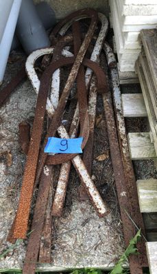 a pile of rusted metal on the ground next to a building