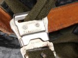 a close up of a helmet with a metal buckle on it