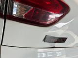a close up of a car ' s tail light with a sticker on it