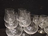 several empty wine glasses are lined up on a table