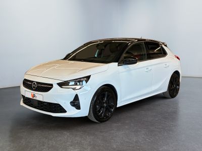 a white car parked in a room with a white wall