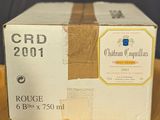 a box of wine sitting on top of a wooden table
