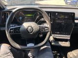someone is sitting in the driver ' s seat of a car with their feet on the steering wheel
