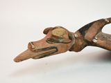 a small wooden object that looks like a dog ' s head
