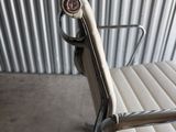 an image of a white office chair in front of a corrugated wall