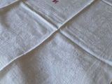 a white blanket with a red cross on it on a bed