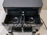 a black and silver machine with two trays on it