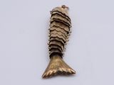 an image of a gold fish pendant on a white background
