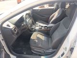 the interior of a car with the door open and the driver ' s seat down