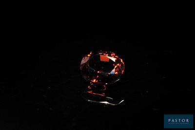 an orange diamond on a black background
