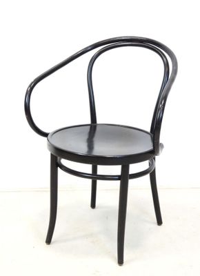 an image of a black chair against a white wall