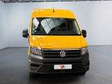 yellow van parked in a white room with a black floor