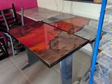 a glass table with a painting on it in a room
