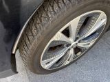 a close up of a car tire on the side of the road