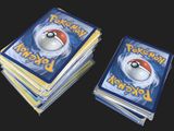 several pokemon cards stacked on top of each other on a black surface