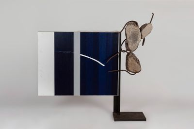 sculpture of a pair of glasses on a stand with a mirror in the background