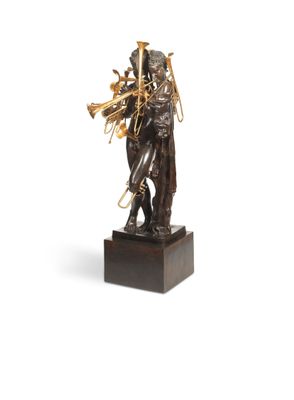 an image of a bronze statue of a man holding a trumpet